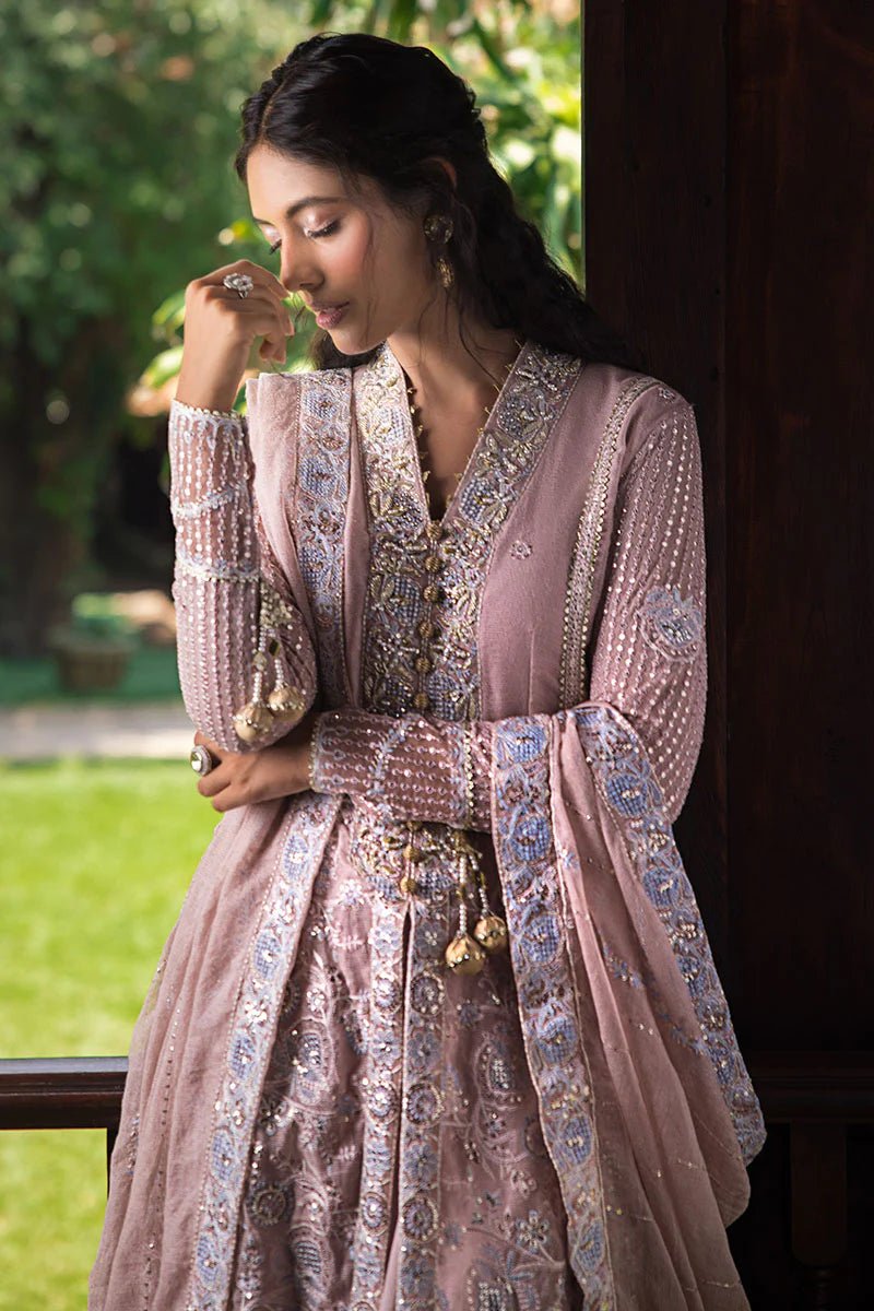 Model wearing Mushq Janvi dress in dusty pink. Shop Pakistani wedding clothes online in the UK. Discover Mushq's Roohi Luxury Collection.