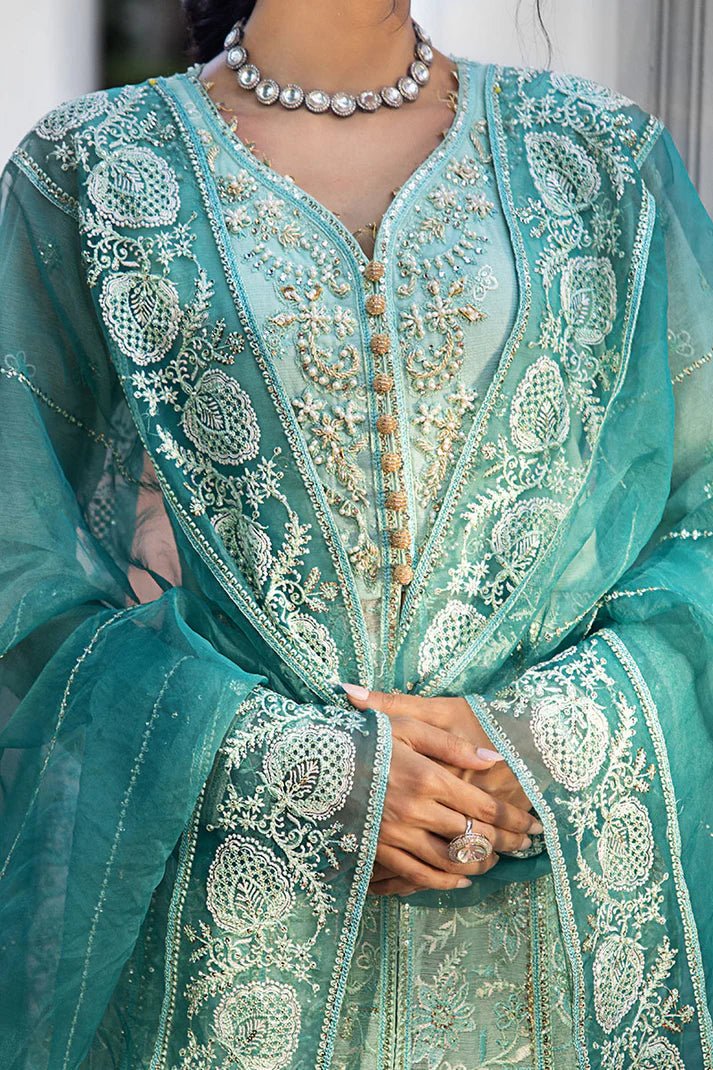 Model wearing a teal Meera dress from Mushq Roohi Luxury Collection. Highlighting Pakistani clothes online in the UK and wedding attire.