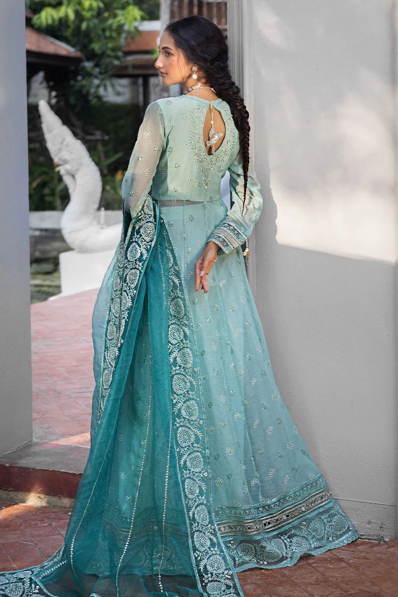 Model wearing a teal Meera dress from Mushq Roohi Luxury Collection. Highlighting Pakistani clothes online in the UK and wedding attire.