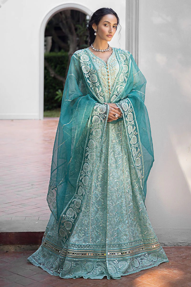 Model wearing a teal Meera dress from Mushq Roohi Luxury Collection. Highlighting Pakistani clothes online in the UK and wedding attire.