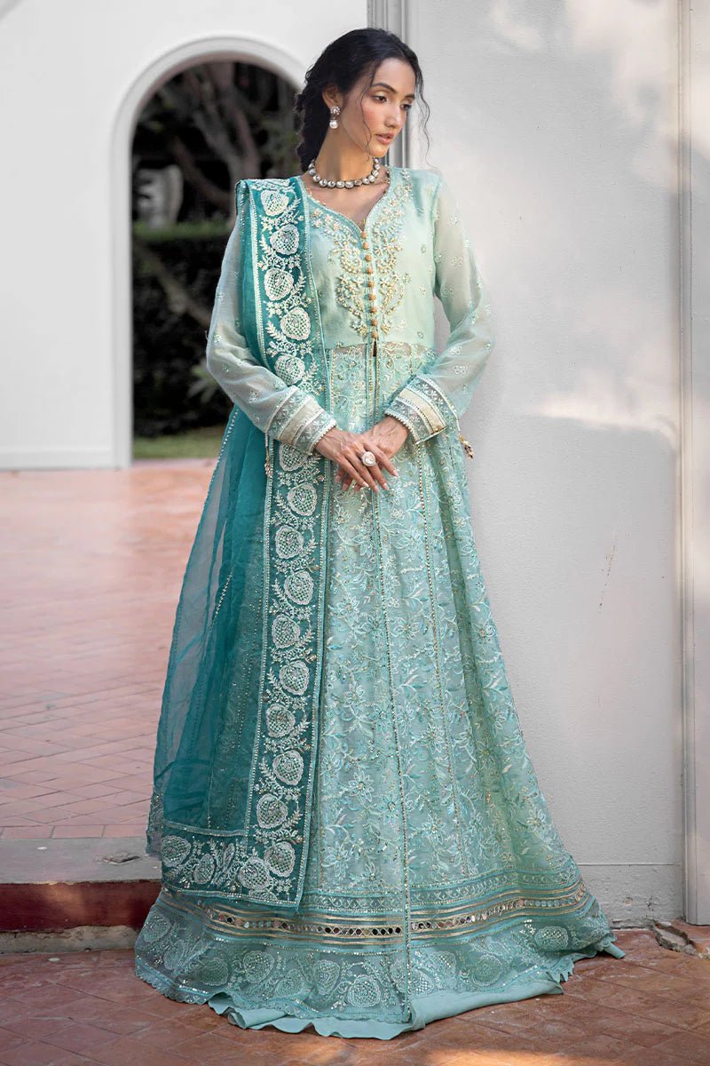 Model wearing a teal Meera dress from Mushq Roohi Luxury Collection. Highlighting Pakistani clothes online in the UK and wedding attire.