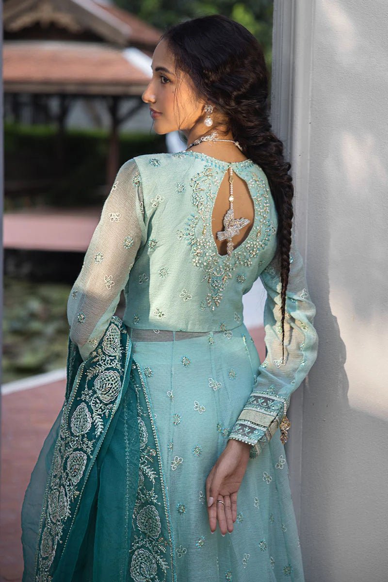 Model wearing a teal Meera dress from Mushq Roohi Luxury Collection. Highlighting Pakistani clothes online in the UK and wedding attire.