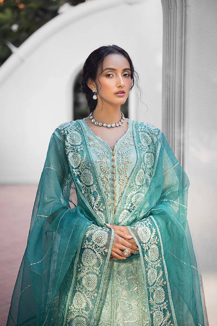 Model wearing a teal Meera dress from Mushq Roohi Luxury Collection. Highlighting Pakistani clothes online in the UK and wedding attire.