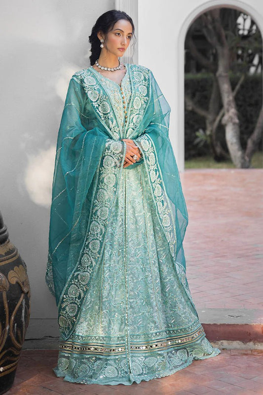 Model wearing a teal Meera dress from Mushq Roohi Luxury Collection. Highlighting Pakistani clothes online in the UK and wedding attire.