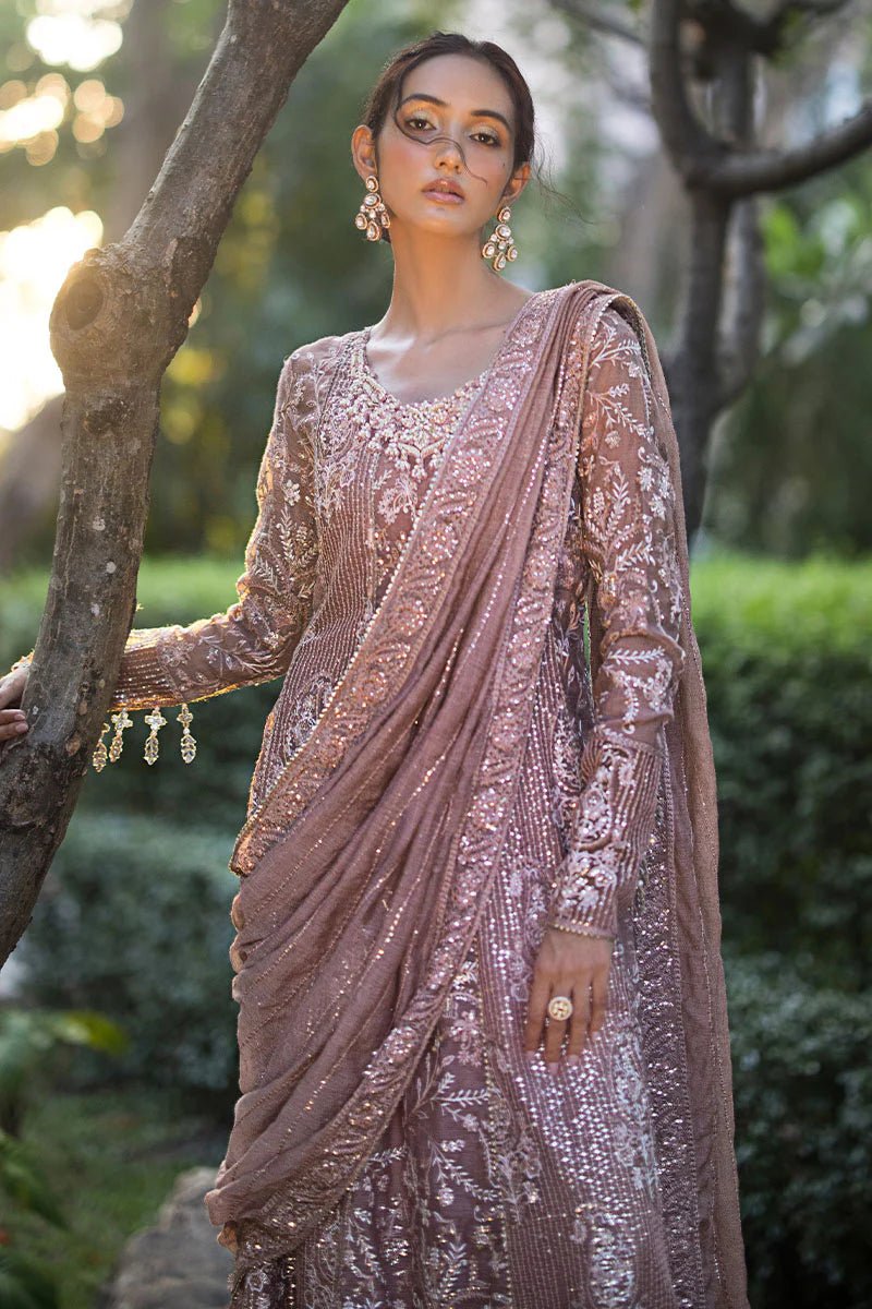 Model wearing a dusty pink Mushq Vaniya dress from the Roohi Luxury Collection. Perfect for weddings. Pakistani clothes online in UK.