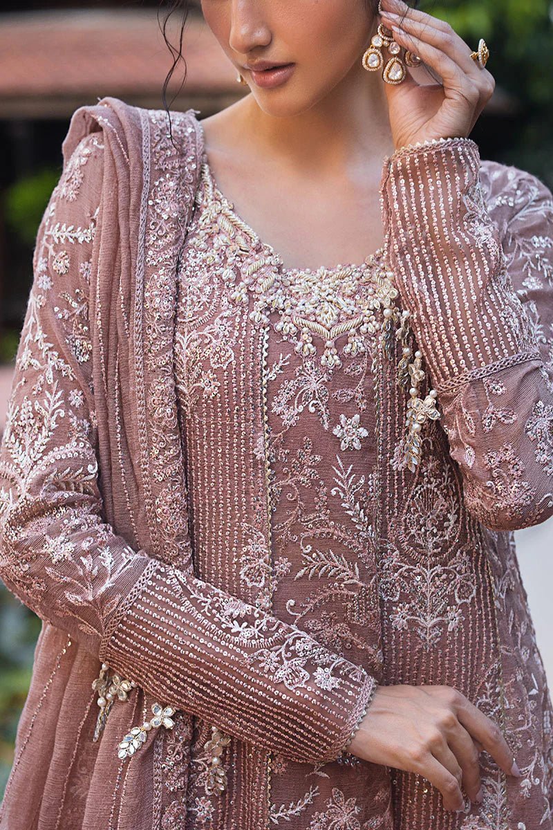 Model wearing a dusty pink Mushq Vaniya dress from the Roohi Luxury Collection. Perfect for weddings. Pakistani clothes online in UK.