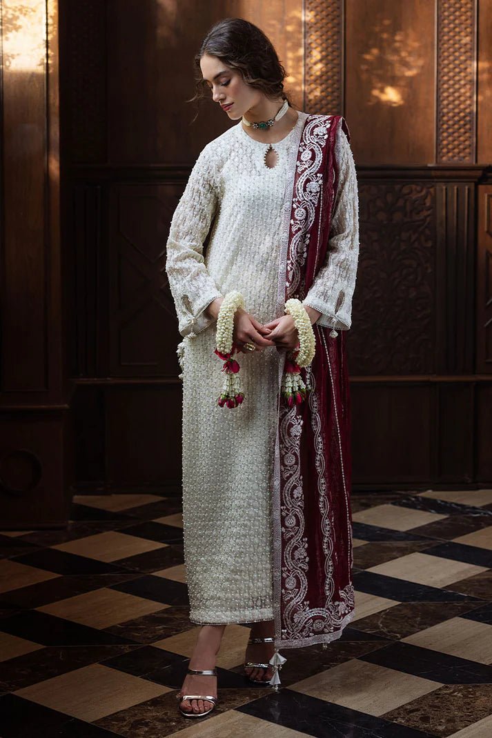 Model wearing white ROYA dress with maroon shawl from Mushq, Saugaat Chickenkari Pret collection. Pakistani designer clothes in UK, readymade clothes, elegant and stylish.