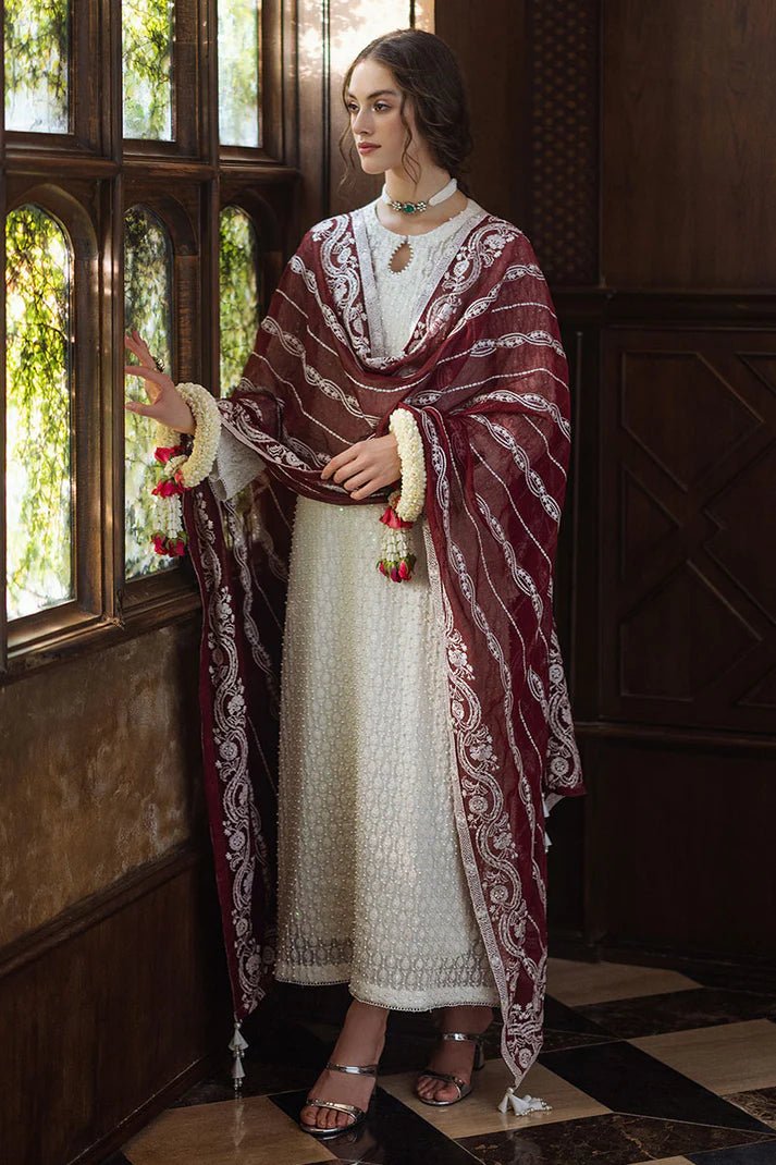 Model wearing white ROYA dress with maroon shawl from Mushq, Saugaat Chickenkari Pret collection. Pakistani designer clothes in UK, readymade clothes, elegant and stylish.