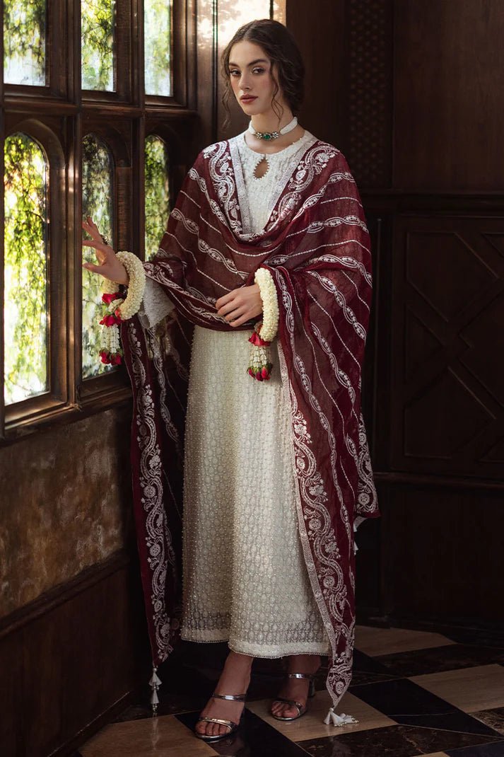 Model wearing white ROYA dress with maroon shawl from Mushq, Saugaat Chickenkari Pret collection. Pakistani designer clothes in UK, readymade clothes, elegant and stylish.