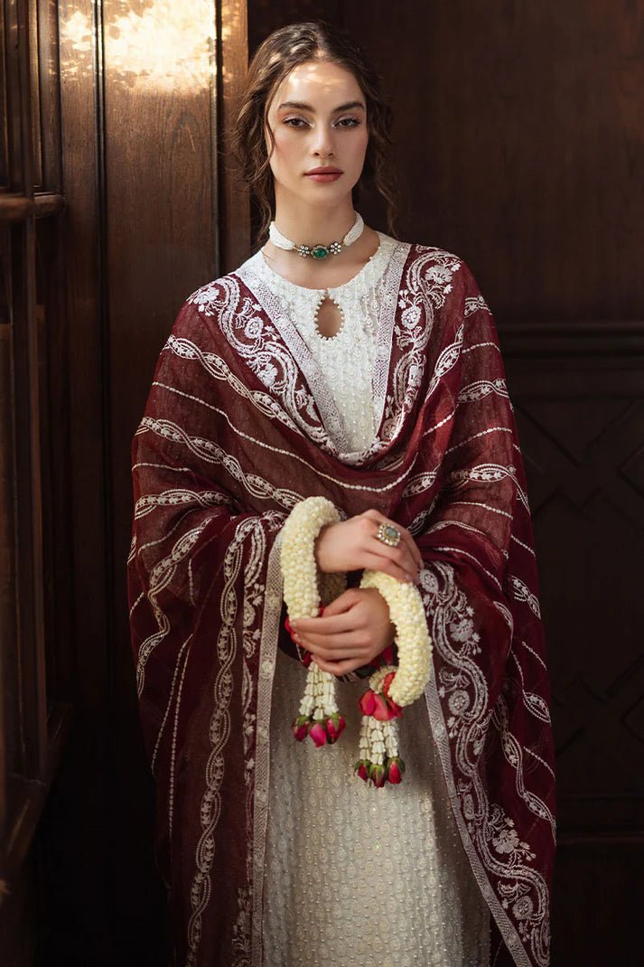 Model wearing white ROYA dress with maroon shawl from Mushq, Saugaat Chickenkari Pret collection. Pakistani designer clothes in UK, readymade clothes, elegant and stylish.