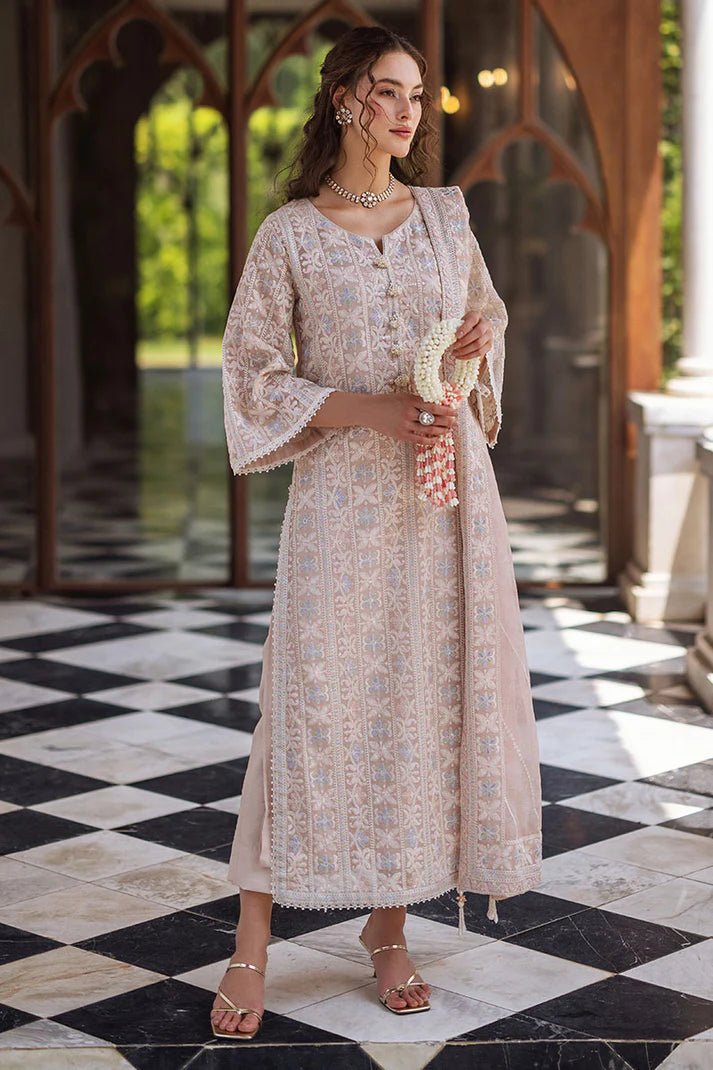 Model wearing a beige SWARA dress from Mushq, Saugaat Chickenkari Pret collection. Pakistani designer clothes in UK, readymade clothes, elegant and stylish.