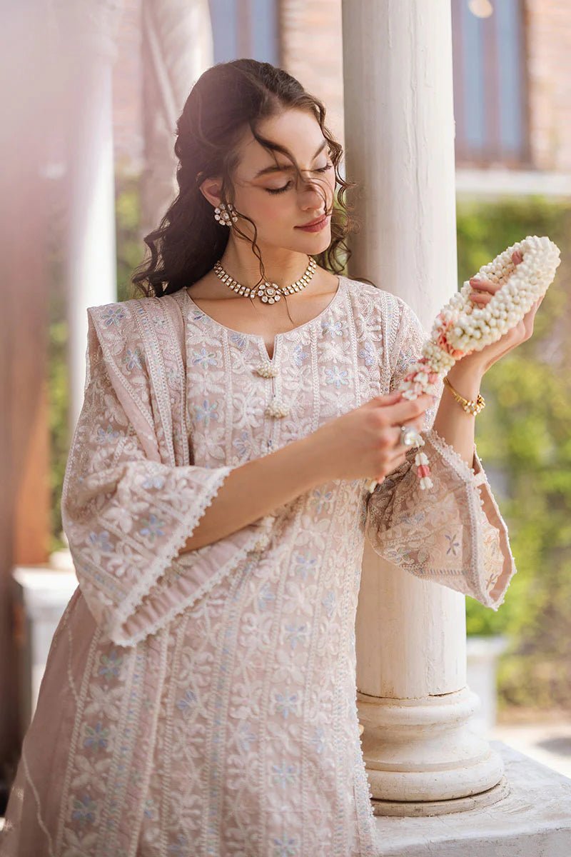 Model wearing a beige SWARA dress from Mushq, Saugaat Chickenkari Pret collection. Pakistani designer clothes in UK, readymade clothes, elegant and stylish.