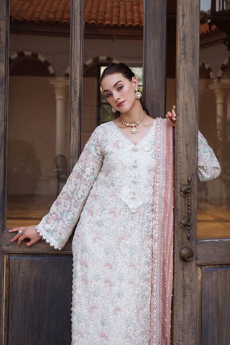 Model wearing a pastel pink and white ZIBA dress from Mushq, Saugaat Chickenkari Pret collection. Pakistani designer clothes in UK, readymade clothes, elegant and stylish.