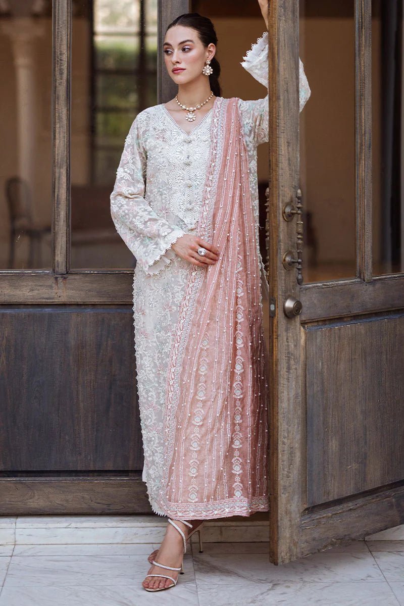 Model wearing a pastel pink and white ZIBA dress from Mushq, Saugaat Chickenkari Pret collection. Pakistani designer clothes in UK, readymade clothes, elegant and stylish.