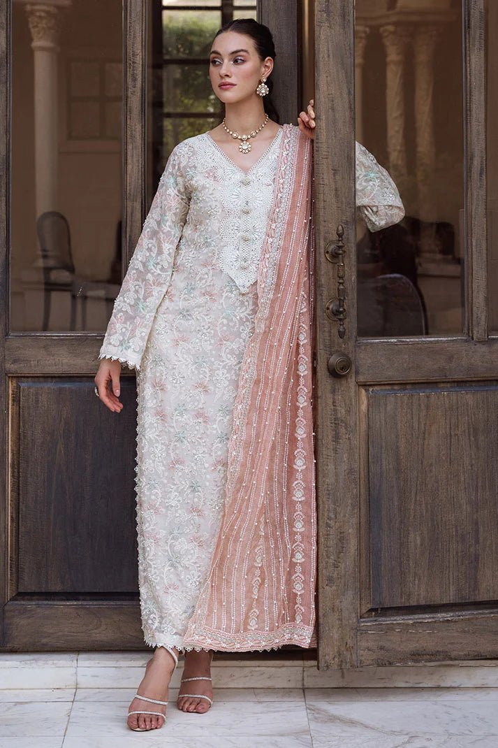 Model wearing a pastel pink and white ZIBA dress from Mushq, Saugaat Chickenkari Pret collection. Pakistani designer clothes in UK, readymade clothes, elegant and stylish.