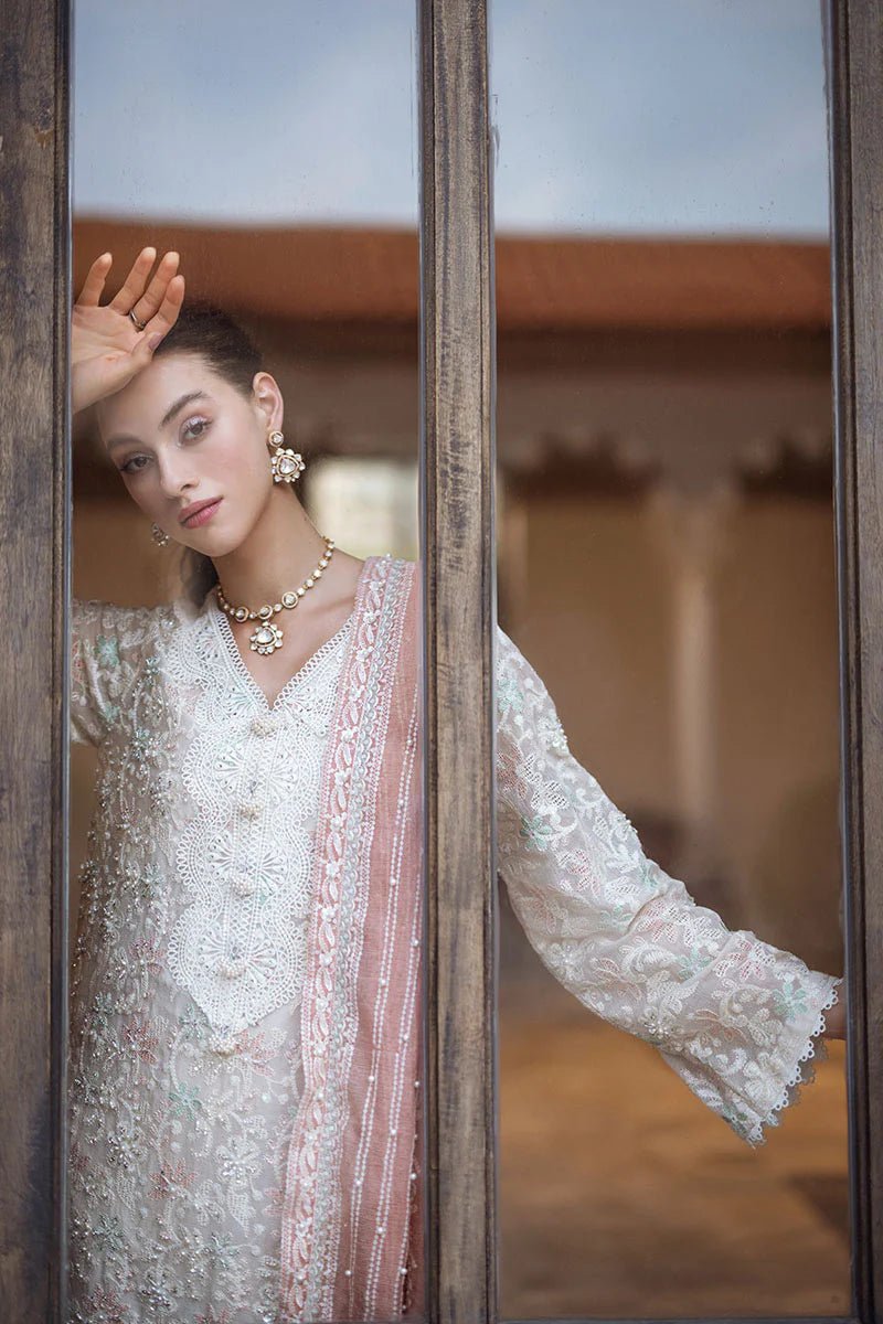 Model wearing a pastel pink and white ZIBA dress from Mushq, Saugaat Chickenkari Pret collection. Pakistani designer clothes in UK, readymade clothes, elegant and stylish.