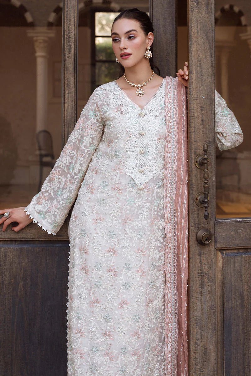 Model wearing a pastel pink and white ZIBA dress from Mushq, Saugaat Chickenkari Pret collection. Pakistani designer clothes in UK, readymade clothes, elegant and stylish.