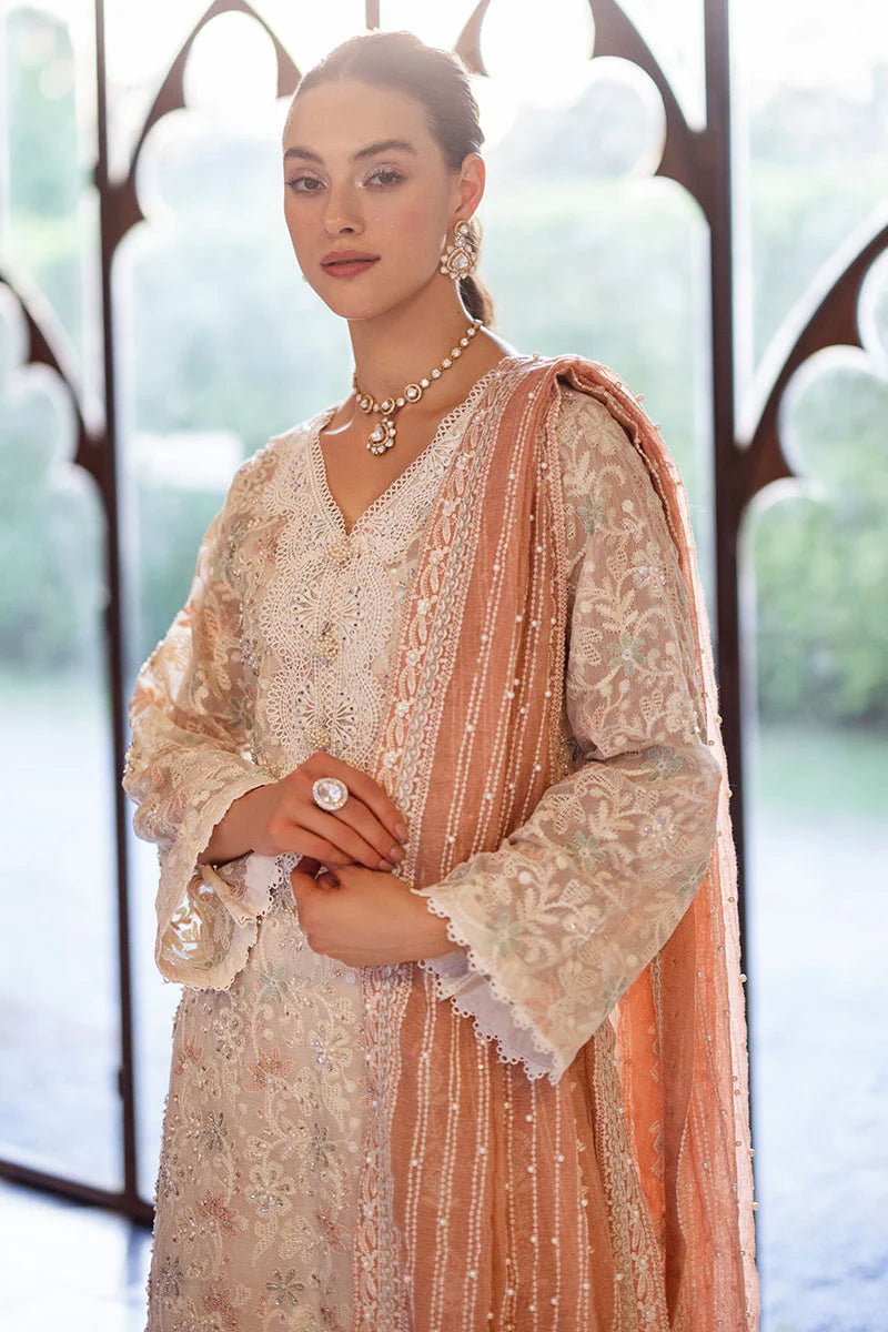 Model wearing a pastel pink and white ZIBA dress from Mushq, Saugaat Chickenkari Pret collection. Pakistani designer clothes in UK, readymade clothes, elegant and stylish.