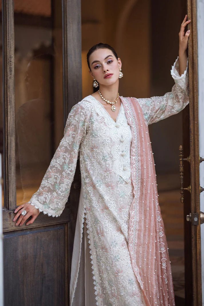 Model wearing a pastel pink and white ZIBA dress from Mushq, Saugaat Chickenkari Pret collection. Pakistani designer clothes in UK, readymade clothes, elegant and stylish.