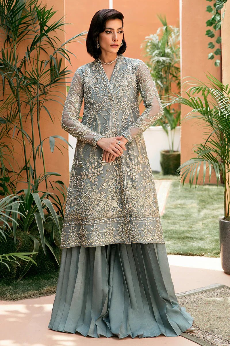 Model wearing Mushq's Amora dress in grey, showcasing Pakistani wedding attire in the UK.