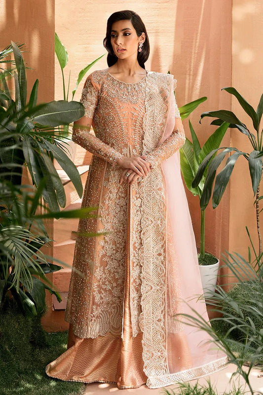 Model wearing Mushq's Corallina dress in peach, highlighting Pakistani wedding fashion in the UK.