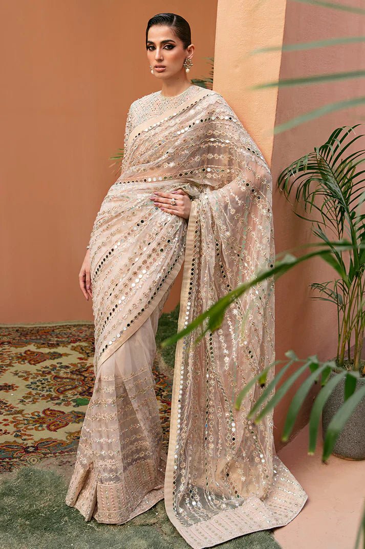 Model wearing Mushq's Fiamma dress from the Tuscany Luxury Formals collection, highlighted by elegant sequins on a champagne fabric, showcasing exquisite Pakistani wedding attire in the UK.