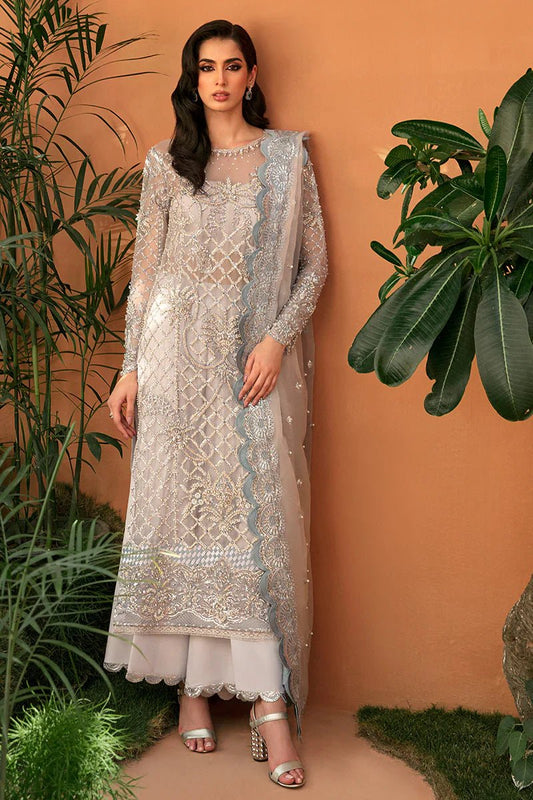 Model wearing Mushq's Martina dress in light gray with detailed embroidery, perfect for showcasing Pakistani designer wedding clothes in the UK.