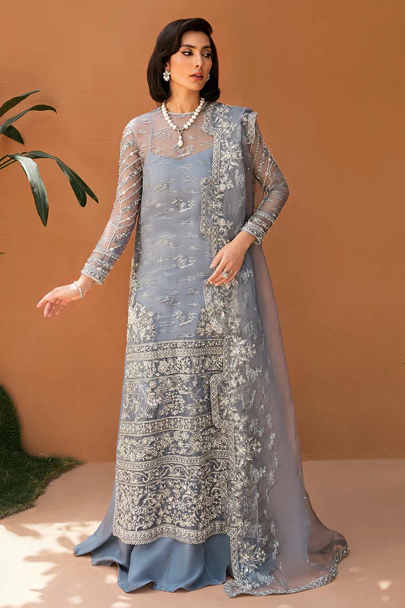 Model wearing Mushq's Sabella dress in soft blue with intricate embroidery, ideal for showcasing Pakistani wedding clothes in the UK.