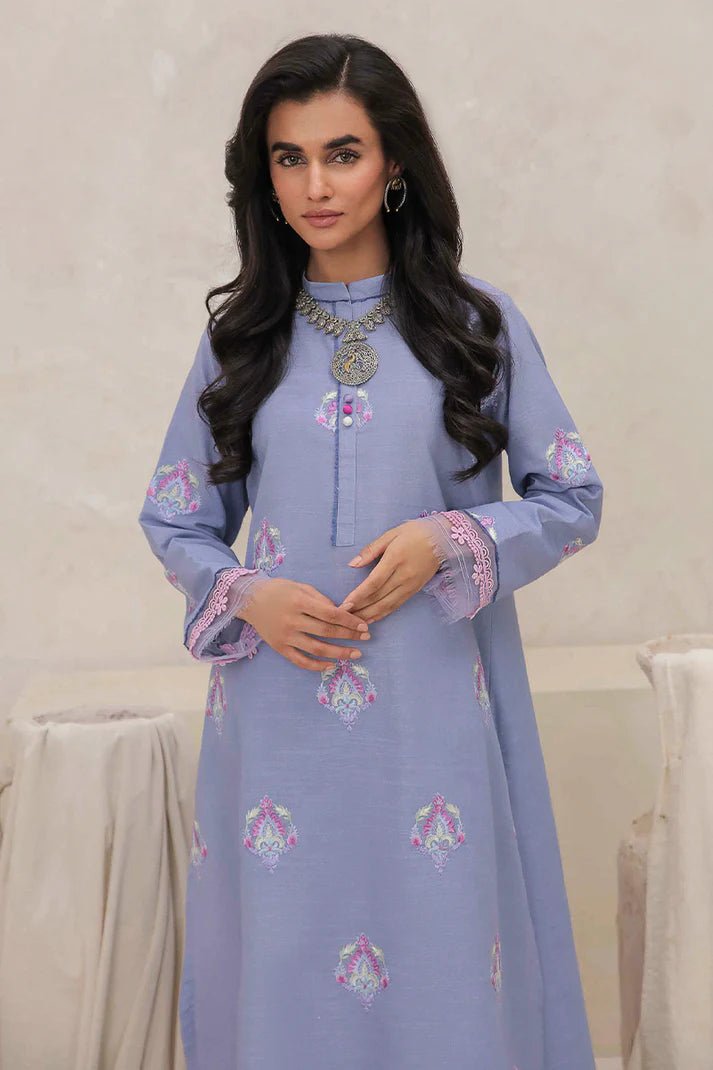 Model wearing Mushq Wisteria Winter Basic Pret '24 Crystal Frost, a light blue dress with delicate embroidery, ideal for winter casual wear. Available for Pakistani clothes online in the UK.