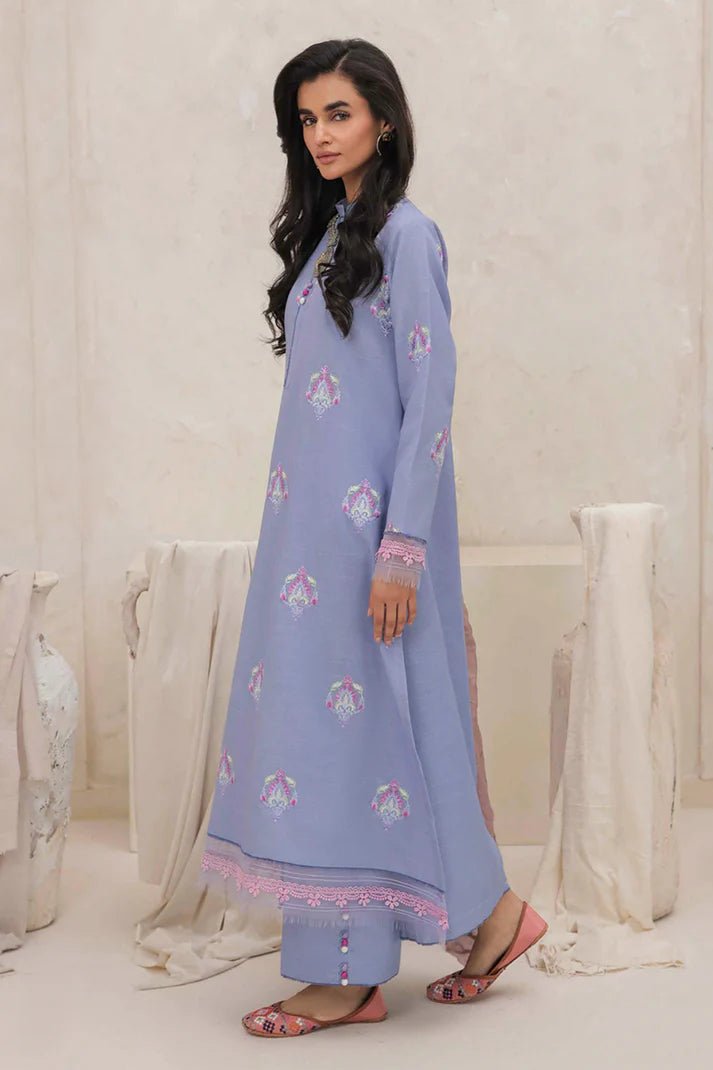 Model wearing Mushq Wisteria Winter Basic Pret '24 Crystal Frost, a light blue dress with delicate embroidery, ideal for winter casual wear. Available for Pakistani clothes online in the UK.