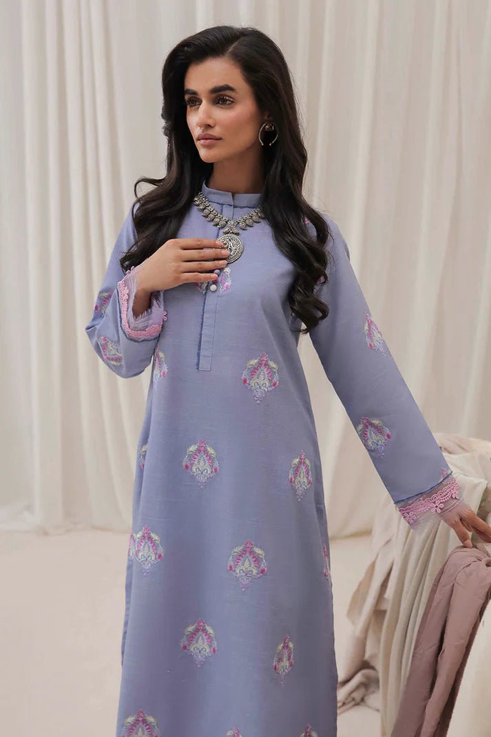 Model wearing Mushq Wisteria Winter Basic Pret '24 Crystal Frost, a light blue dress with delicate embroidery, ideal for winter casual wear. Available for Pakistani clothes online in the UK.