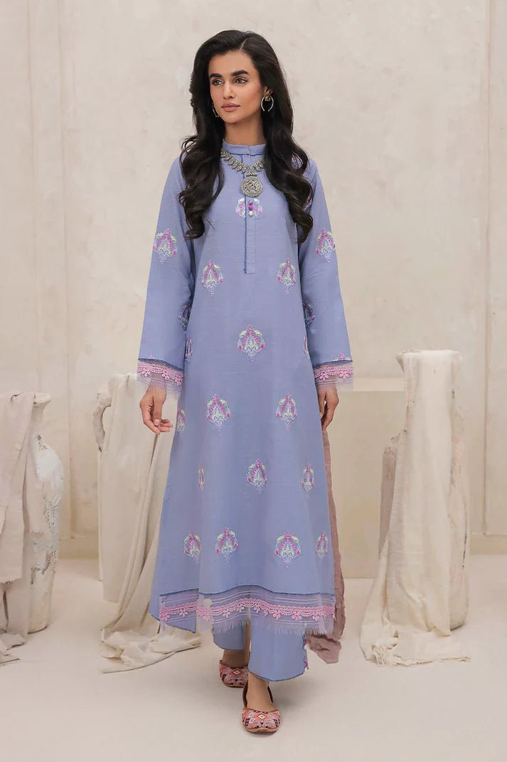 Model wearing Mushq Wisteria Winter Basic Pret '24 Crystal Frost, a light blue dress with delicate embroidery, ideal for winter casual wear. Available for Pakistani clothes online in the UK.