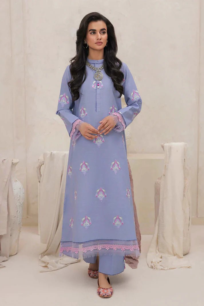 Model wearing Mushq Wisteria Winter Basic Pret '24 Crystal Frost, a light blue dress with delicate embroidery, ideal for winter casual wear. Available for Pakistani clothes online in the UK.