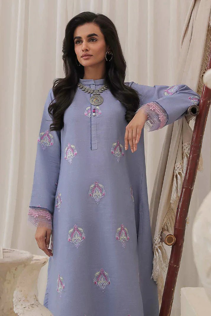 Model wearing Mushq Wisteria Winter Basic Pret '24 Crystal Frost, a light blue dress with delicate embroidery, ideal for winter casual wear. Available for Pakistani clothes online in the UK.