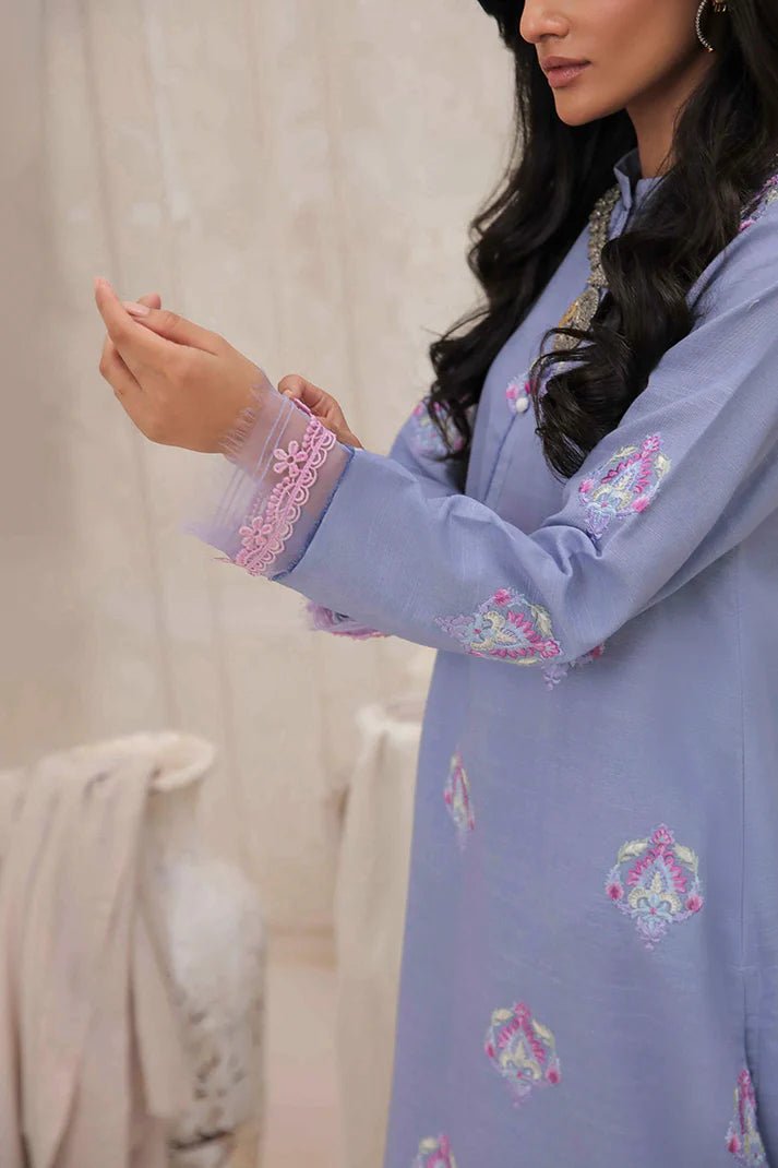 Model wearing Mushq Wisteria Winter Basic Pret '24 Crystal Frost, a light blue dress with delicate embroidery, ideal for winter casual wear. Available for Pakistani clothes online in the UK.