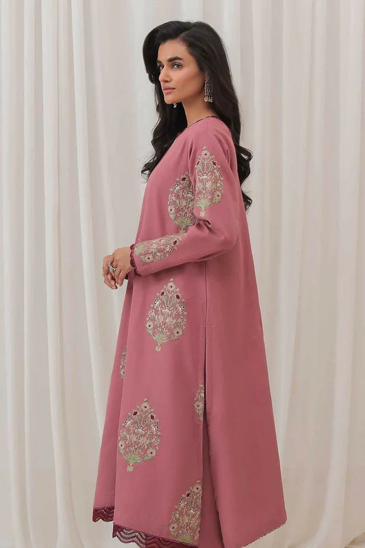 Model wearing Mushq Wisteria Winter Basic Pret '24 Polar Vogue, a rose pink dress with intricate embroidery, ideal for winter casual wear. Available for Pakistani clothes online in the UK.