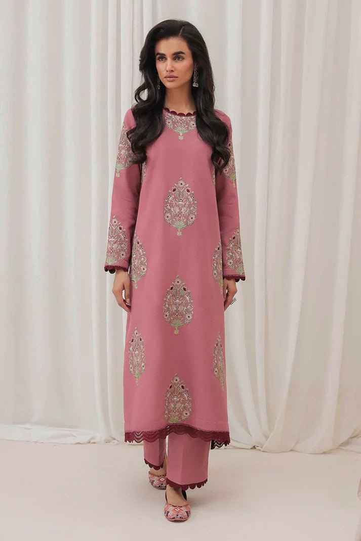 Model wearing Mushq Wisteria Winter Basic Pret '24 Polar Vogue, a rose pink dress with intricate embroidery, ideal for winter casual wear. Available for Pakistani clothes online in the UK.