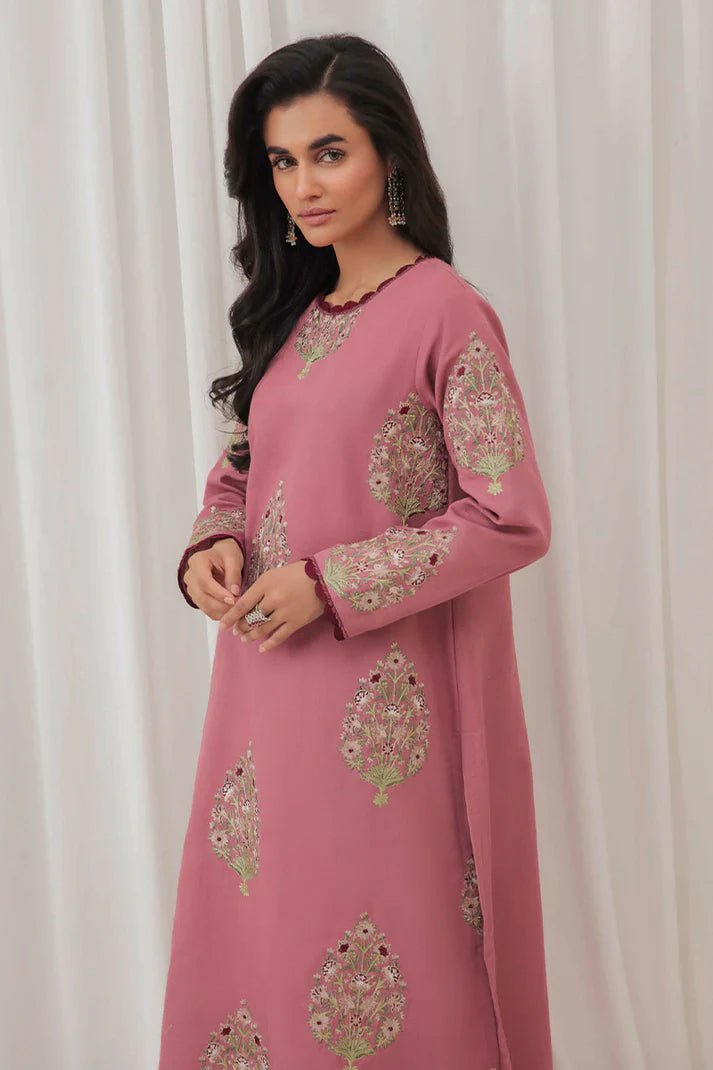 Model wearing Mushq Wisteria Winter Basic Pret '24 Polar Vogue, a rose pink dress with intricate embroidery, ideal for winter casual wear. Available for Pakistani clothes online in the UK.