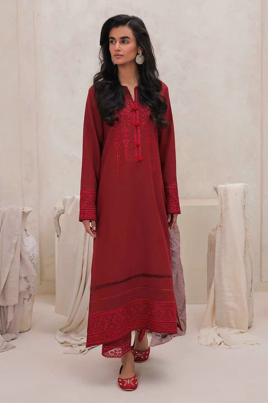 Model wearing Mushq Wisteria Winter Basic Pret '24 Red Wonder, a vibrant red dress with intricate embroidery, perfect for winter casual wear. Available for Pakistani clothes online in the UK.