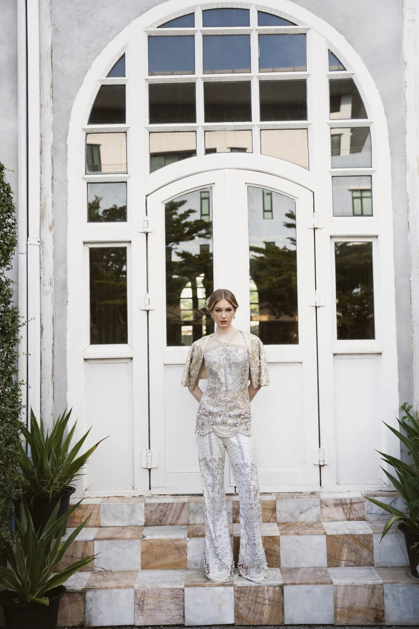 Model wearing a gold and white embellished DOJA dress from Mysie by Tahira. Perfect for weddings. Pakistani clothes online in the UK.