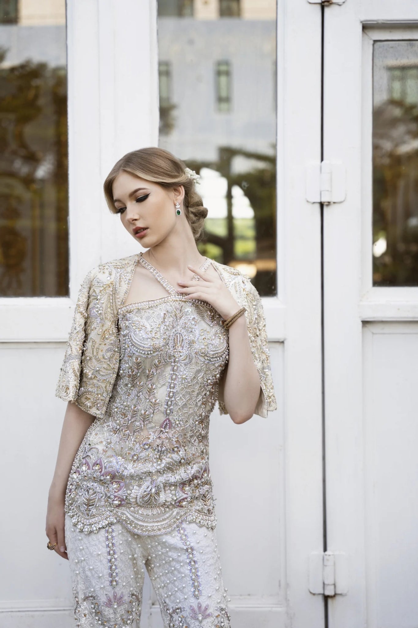 Model wearing a gold and white embellished DOJA dress from Mysie by Tahira. Perfect for weddings. Pakistani clothes online in the UK.