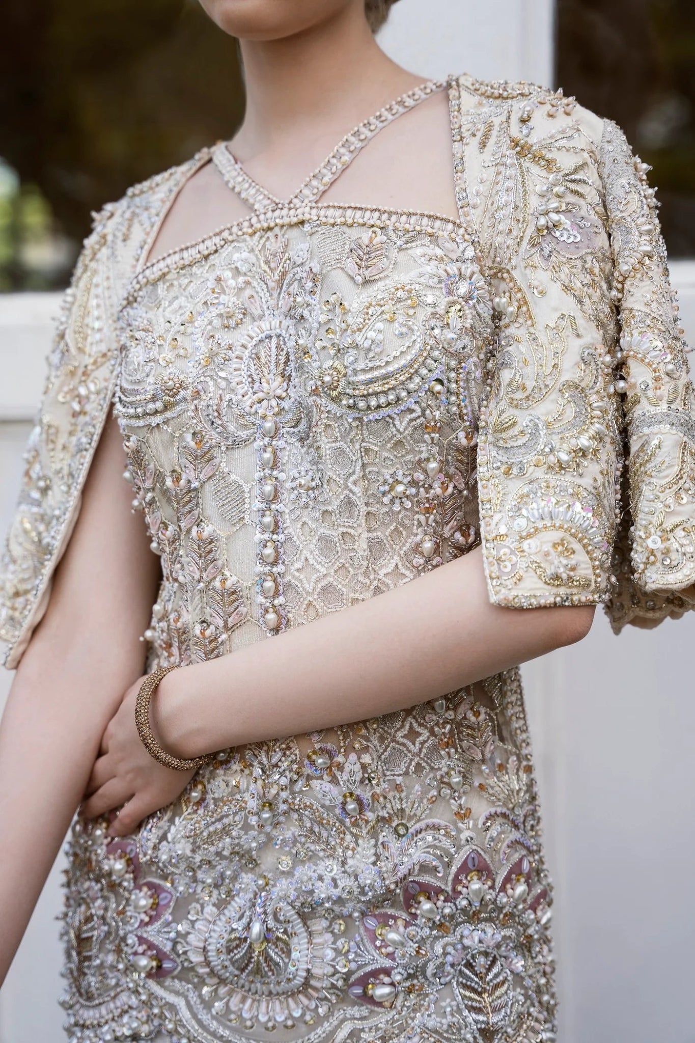 Model wearing a gold and white embellished DOJA dress from Mysie by Tahira. Perfect for weddings. Pakistani clothes online in the UK.