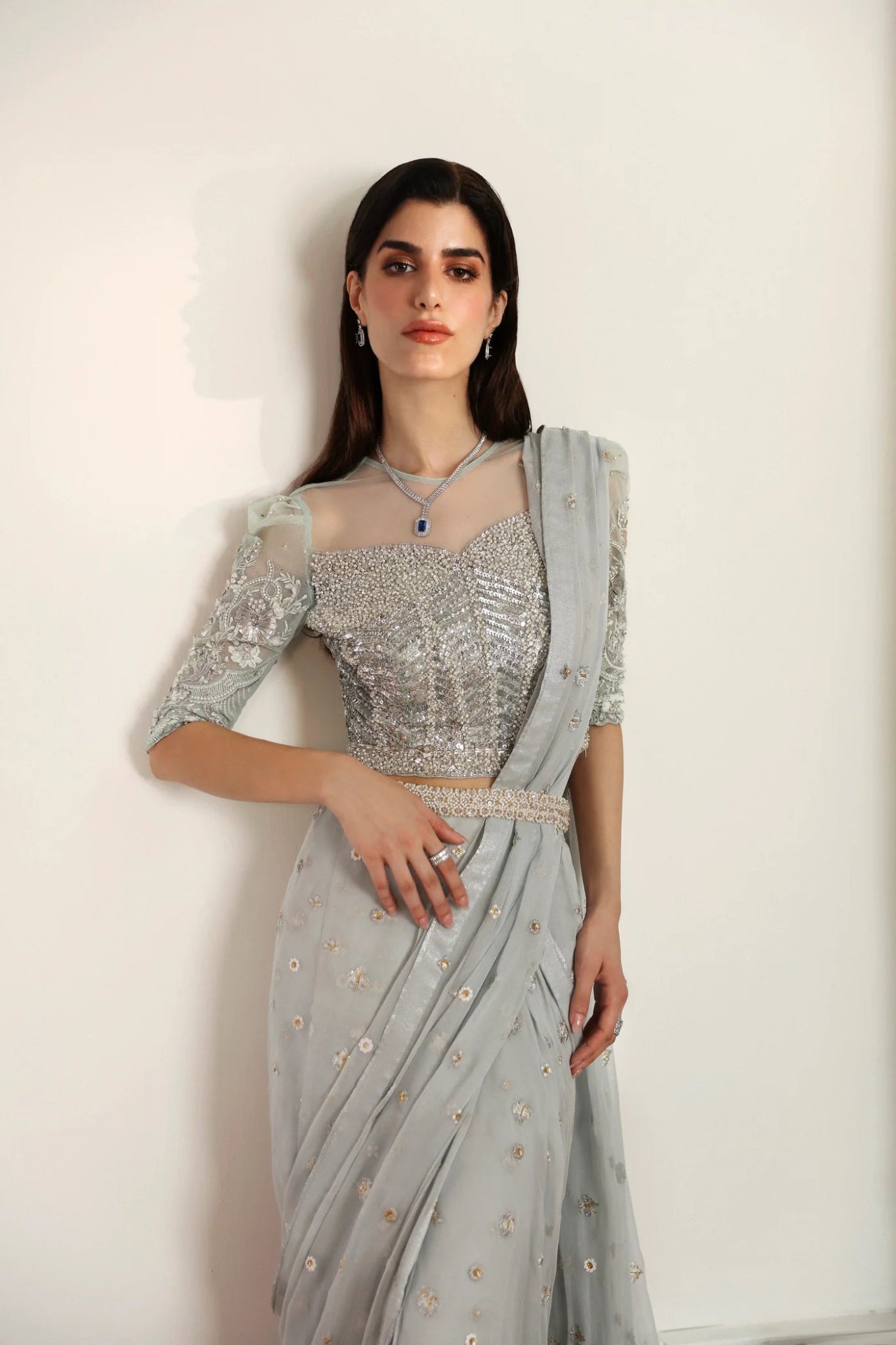 Model wearing Hafsa from Mysie by Tahira in a silver - grey embellished saree. Pakistani clothes online in UK, ideal for weddings and formal events.