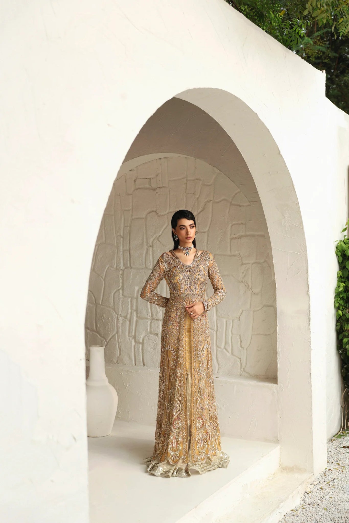 Model wearing Humaira from Mysie by Tahira in a gold embellished bridal gown. Pakistani clothes online in UK, perfect for weddings and formal events.