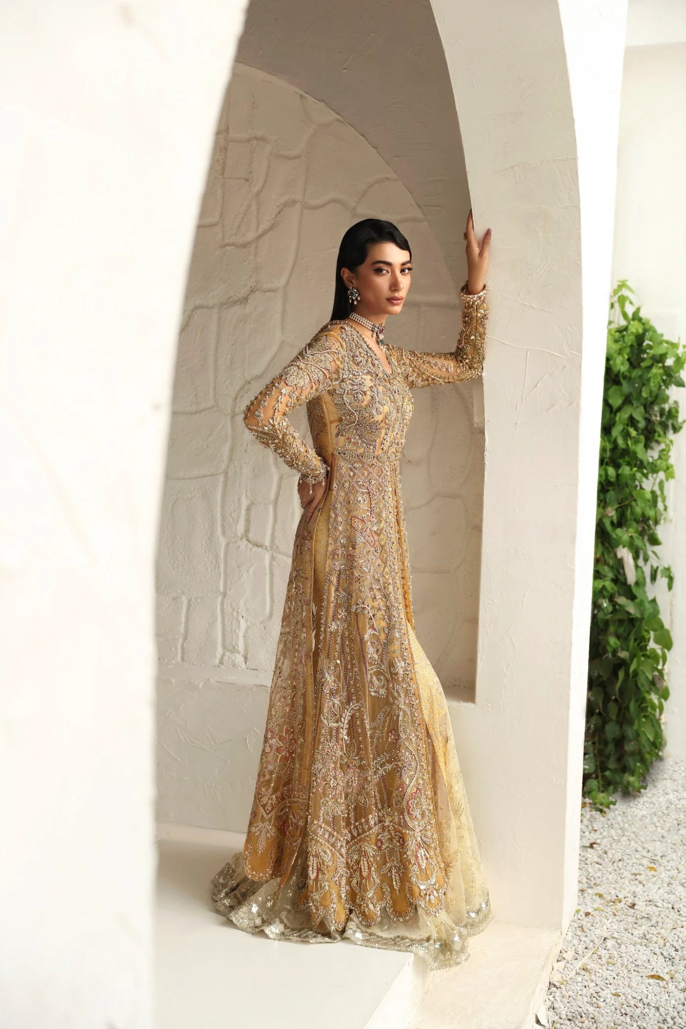 Model wearing Humaira from Mysie by Tahira in a gold embellished bridal gown. Pakistani clothes online in UK, perfect for weddings and formal events.