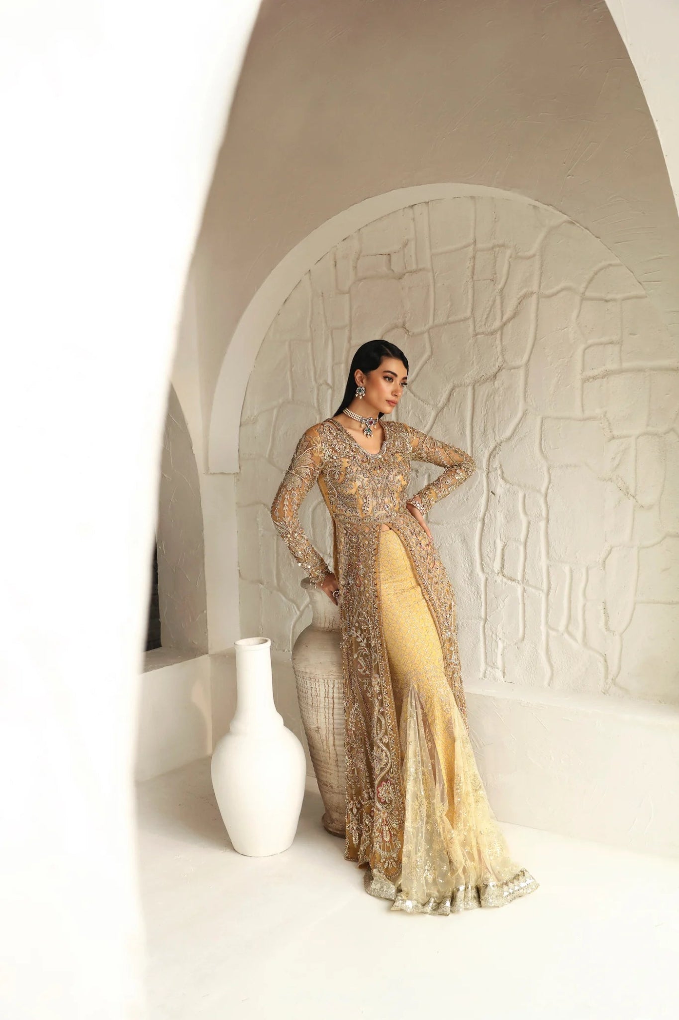 Model wearing Humaira from Mysie by Tahira in a gold embellished bridal gown. Pakistani clothes online in UK, perfect for weddings and formal events.