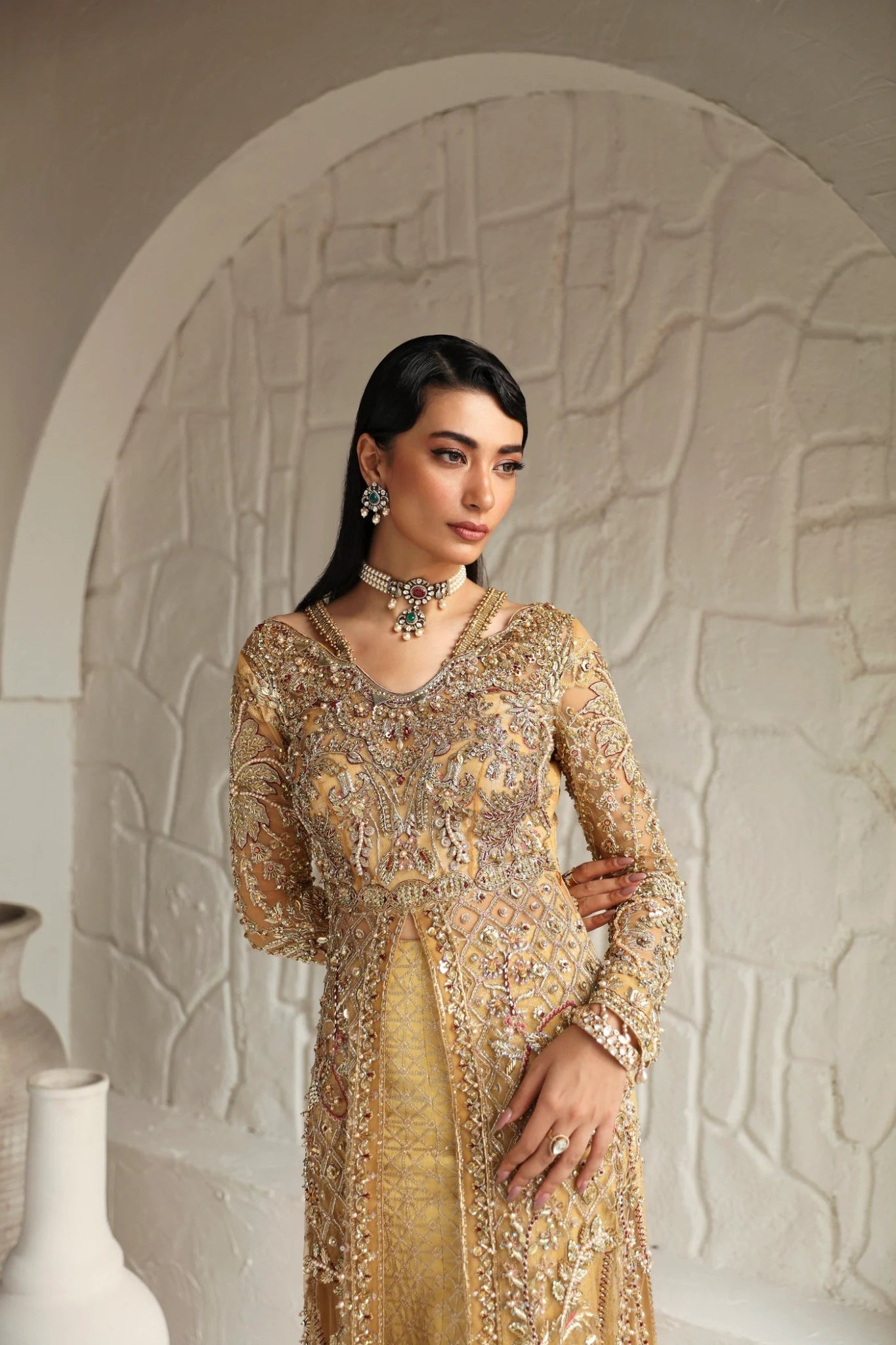 Model wearing Humaira from Mysie by Tahira in a gold embellished bridal gown. Pakistani clothes online in UK, perfect for weddings and formal events.