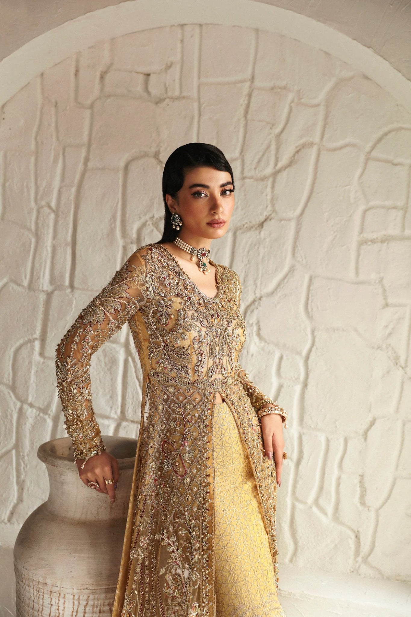 Model wearing Humaira from Mysie by Tahira in a gold embellished bridal gown. Pakistani clothes online in UK, perfect for weddings and formal events.