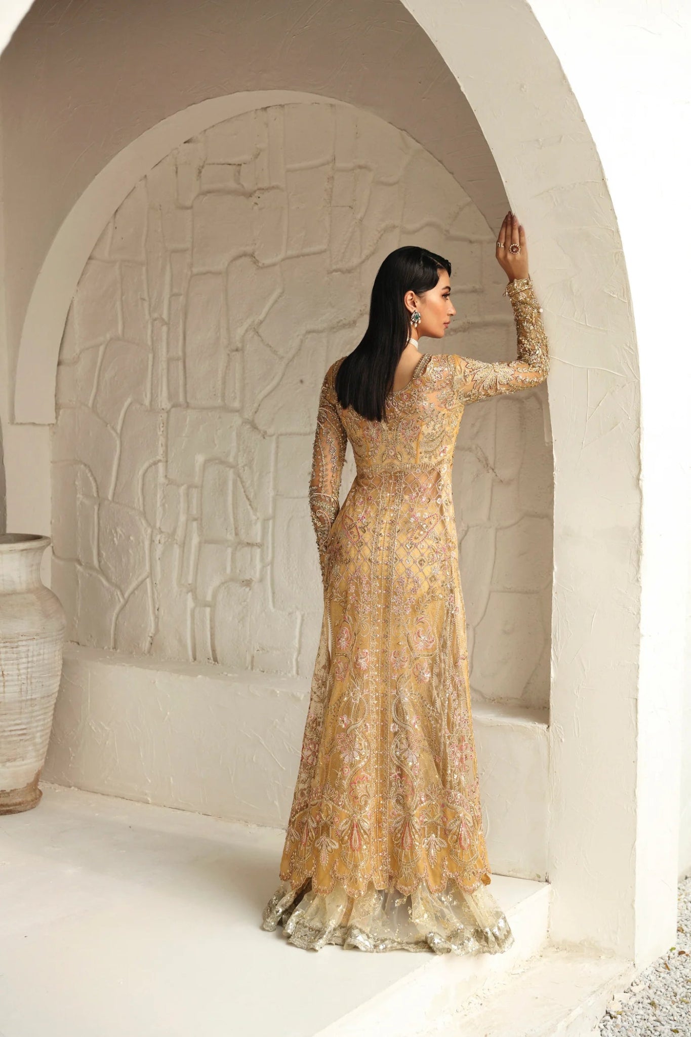 Model wearing Humaira from Mysie by Tahira in a gold embellished bridal gown. Pakistani clothes online in UK, perfect for weddings and formal events.