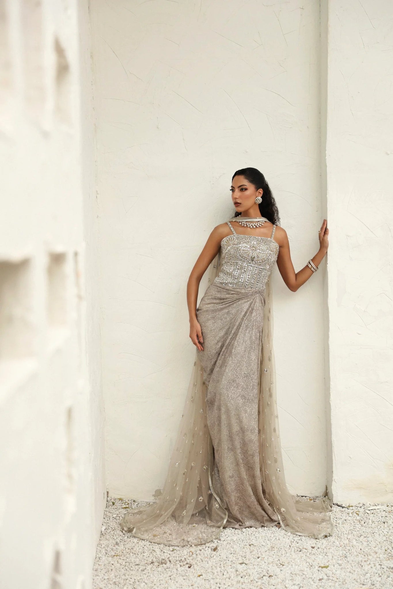 Model wearing Melody from Mysie by Tahira in a silver - beige embellished gown. Pakistani clothes online in UK, perfect for weddings and formal events.